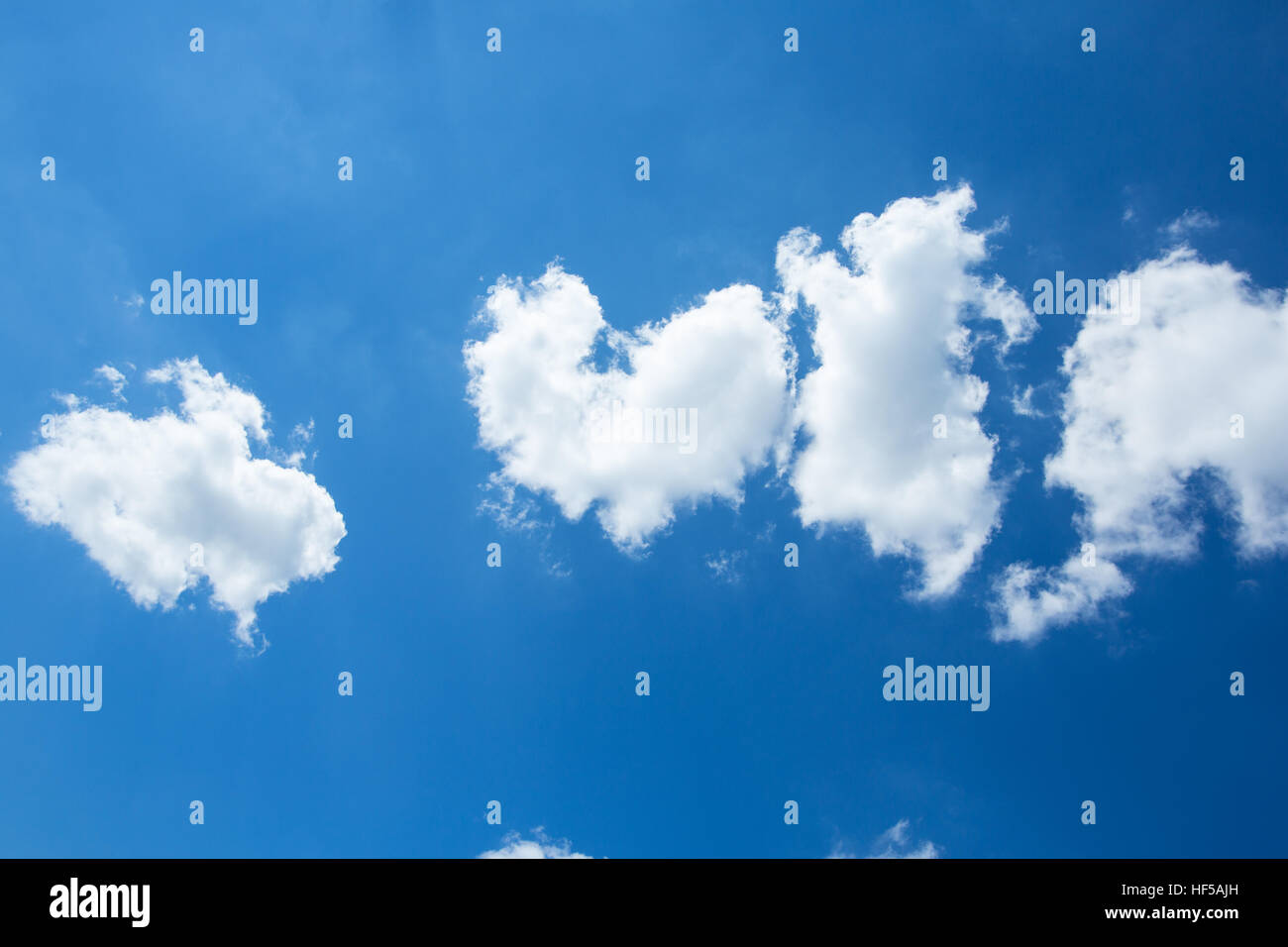 Puffy White Clouds in a Blue Sky Stock Photo - Alamy