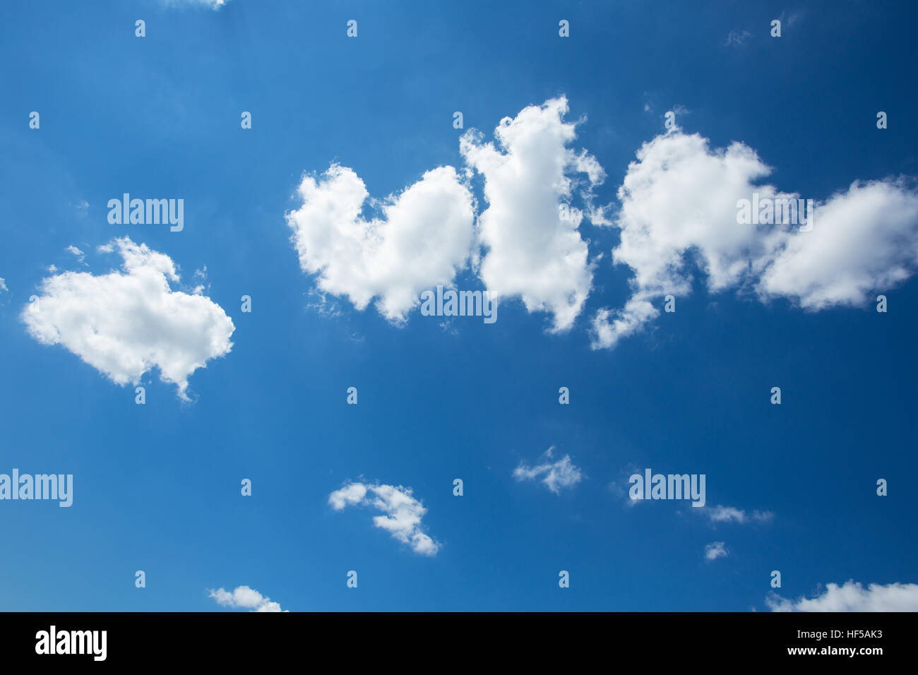 Puffy White Clouds in a Blue Sky Stock Photo - Alamy
