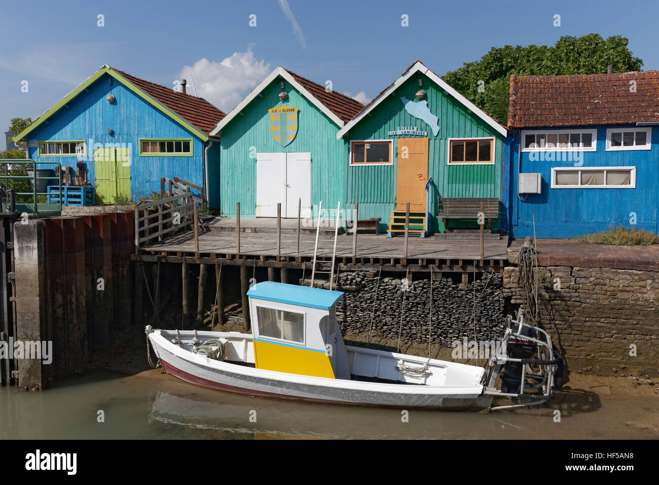 Colorful huts of oyster farmers and boat on a canal, Le Château-d'Oléron, Oléron, Charente-Maritime, France Stock Photo