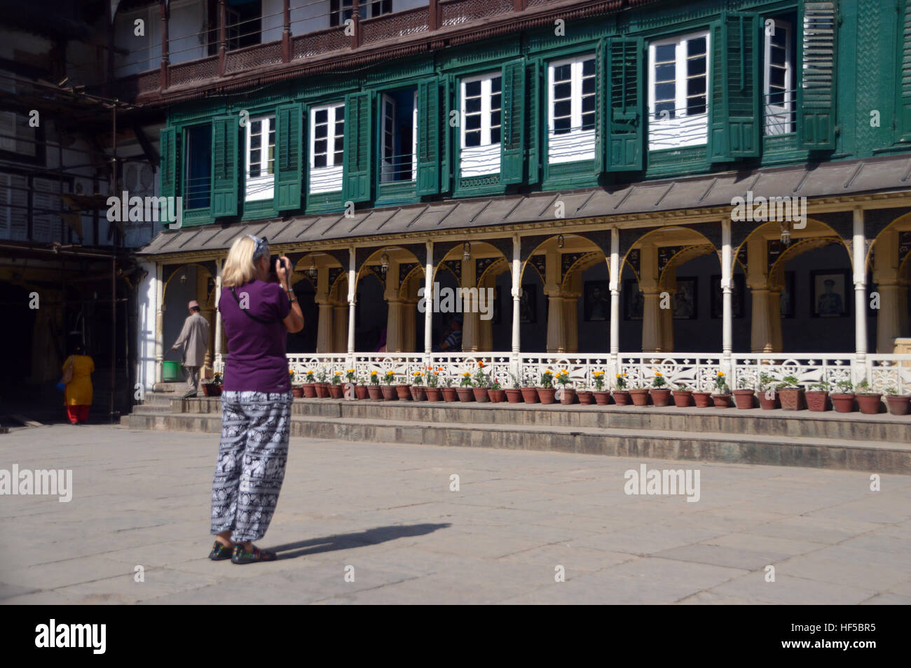 Female Tourist Taking Photos in the Courtyard of the Hanuman Dhoka Durbar Square Museum in Kathmandu, Nepal.Asia. Stock Photo