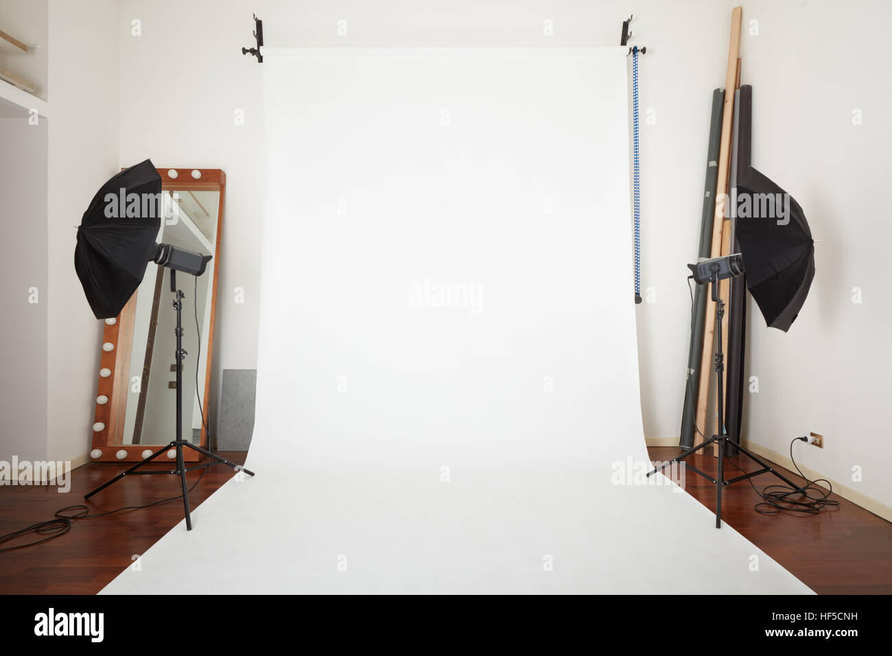 Photographic studio interior with white blank paper background Stock Photo