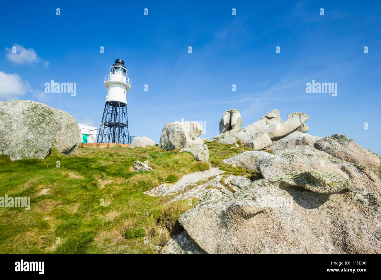 Penninis Lighthouse surrounded by rocks, Isles of Scilly, UK, March 2015 Stock Photo