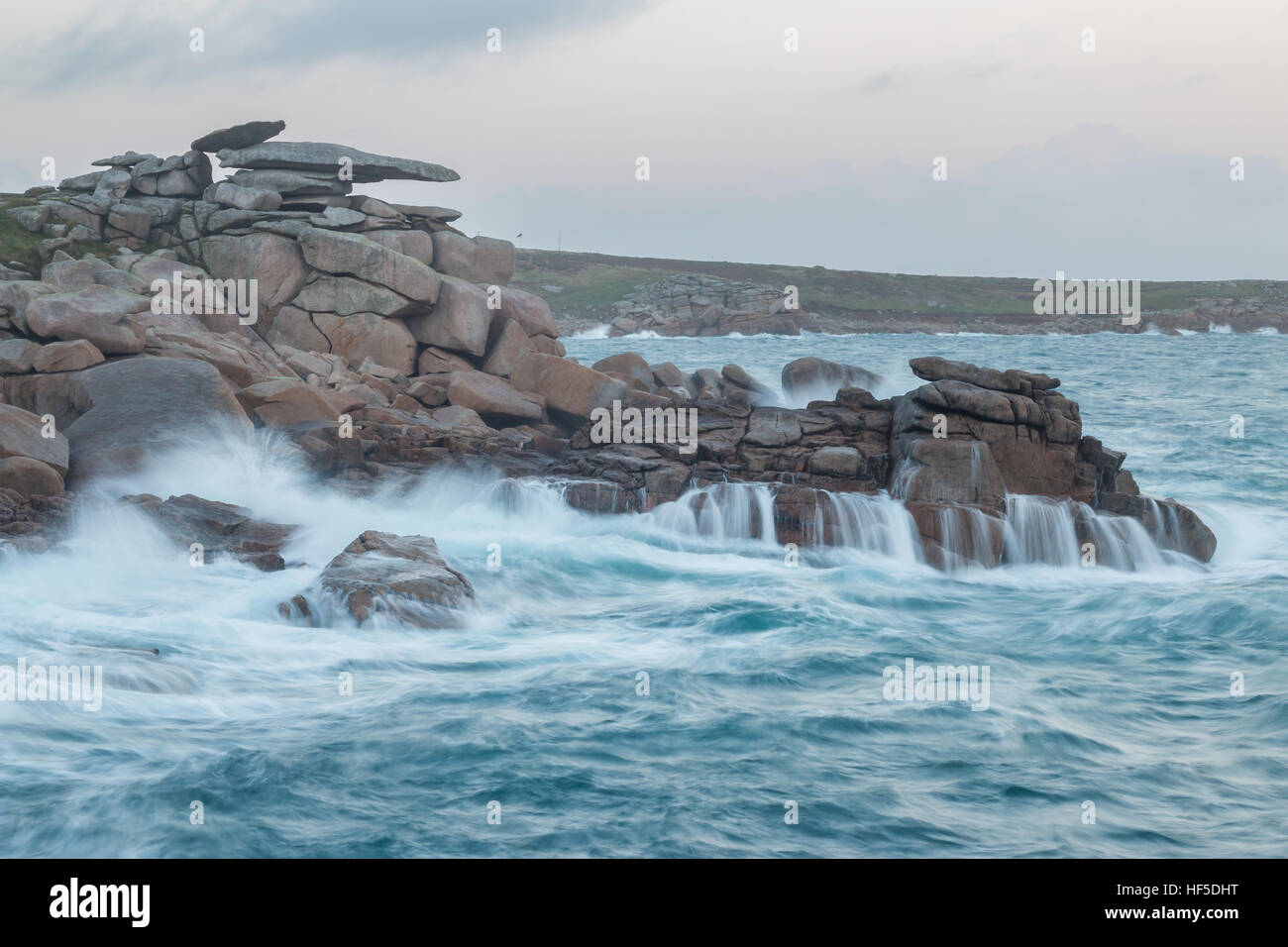 Waves wash over the rocky coast underneath Pulpit Rock on Peninnis, St Mary's, Isles of Scilly Stock Photo