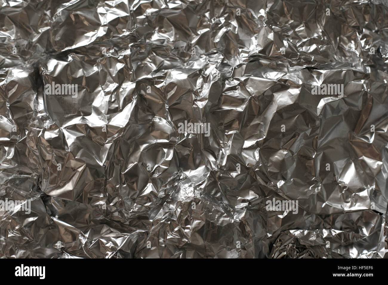 Silver foil background with shiny crumpled surface. Texture Stock Photo ...