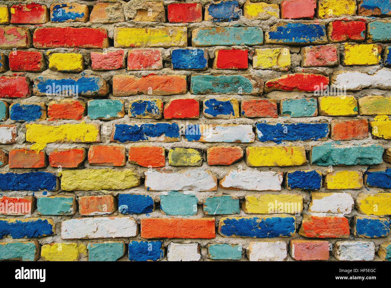 Multicolored painted bricks, exterior wall as background, urban pattern Stock Photo