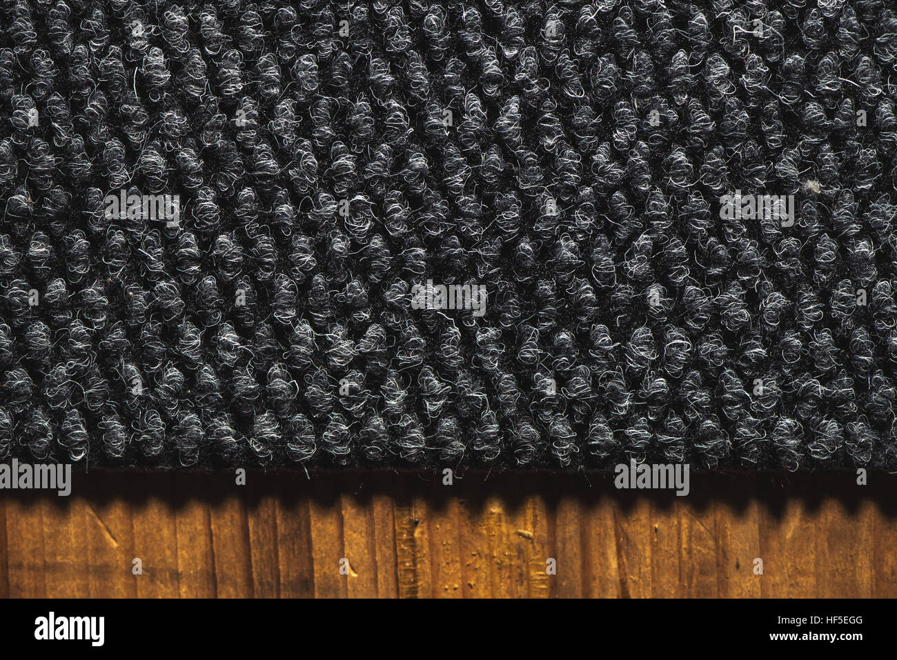 Rough dark carpet texture as background, macro Stock Photo