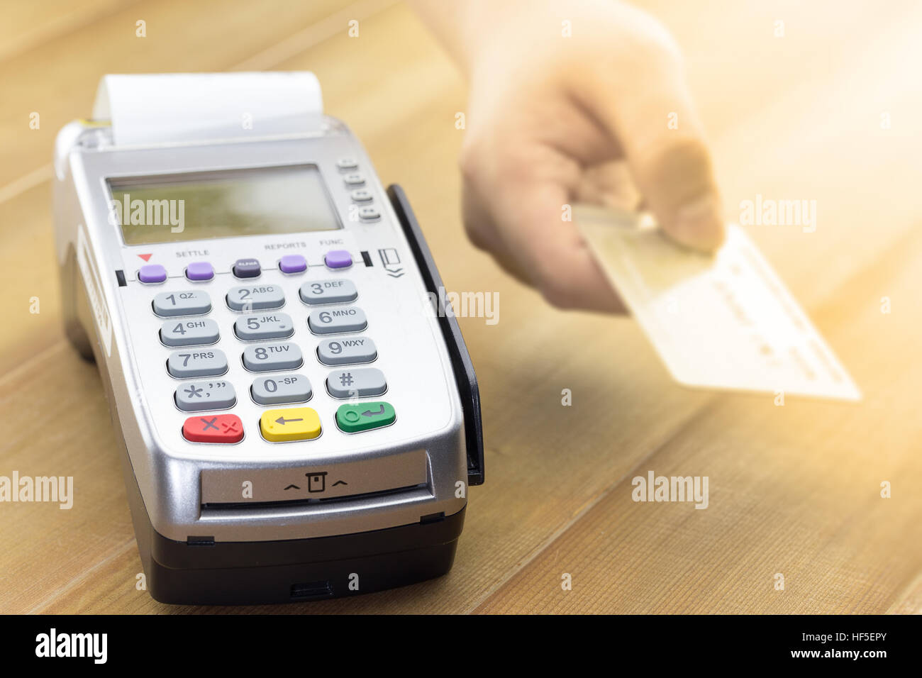 Customers send a credit card payment to cashier for payment over credit card terminal or EDC. Stock Photo