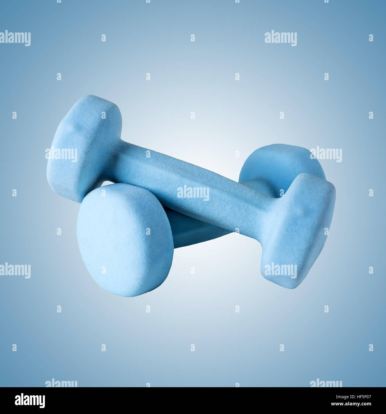 Two blue dumbbells on gradient background Stock Photo - Alamy