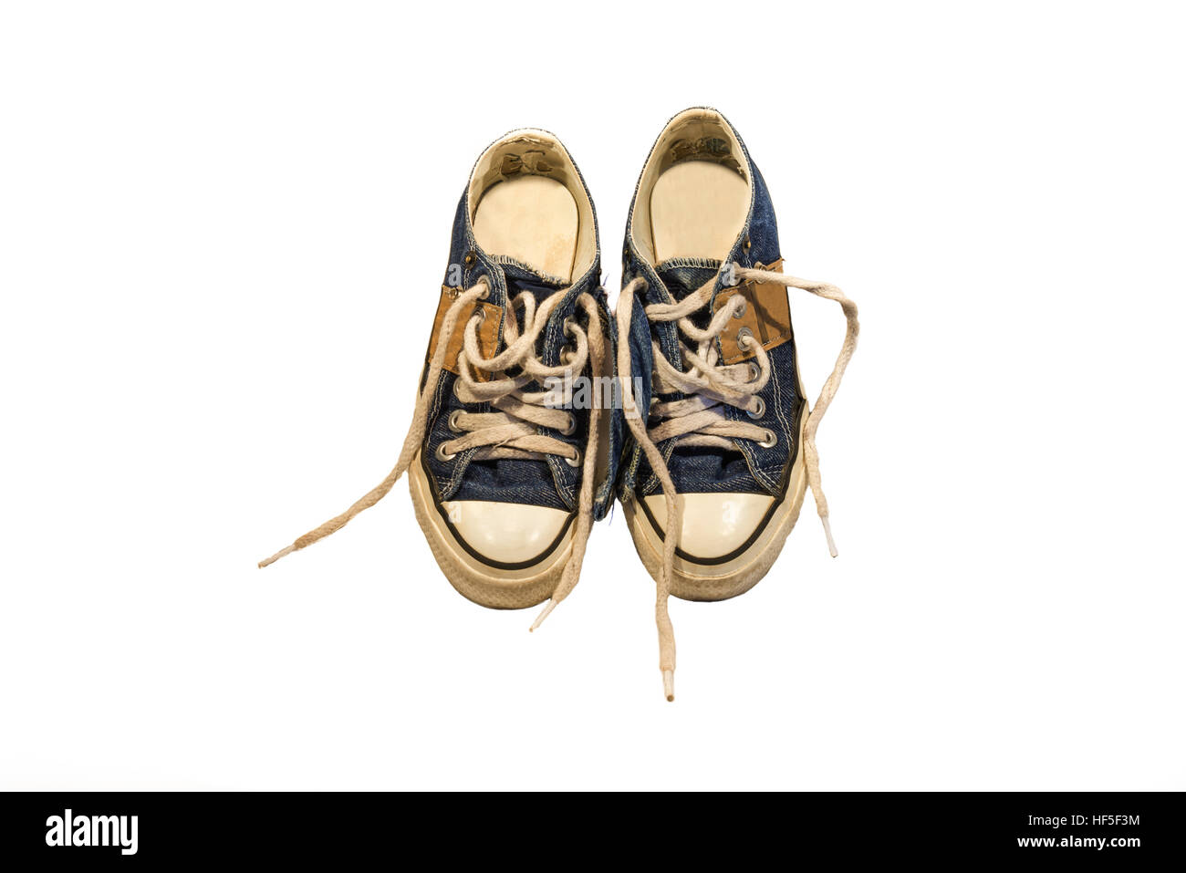 pair of worn blue jean shoes on white background Stock Photo - Alamy