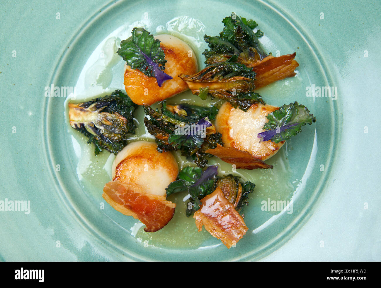 Kalettes being prepared, cooked and served in a scallop dish Stock Photo