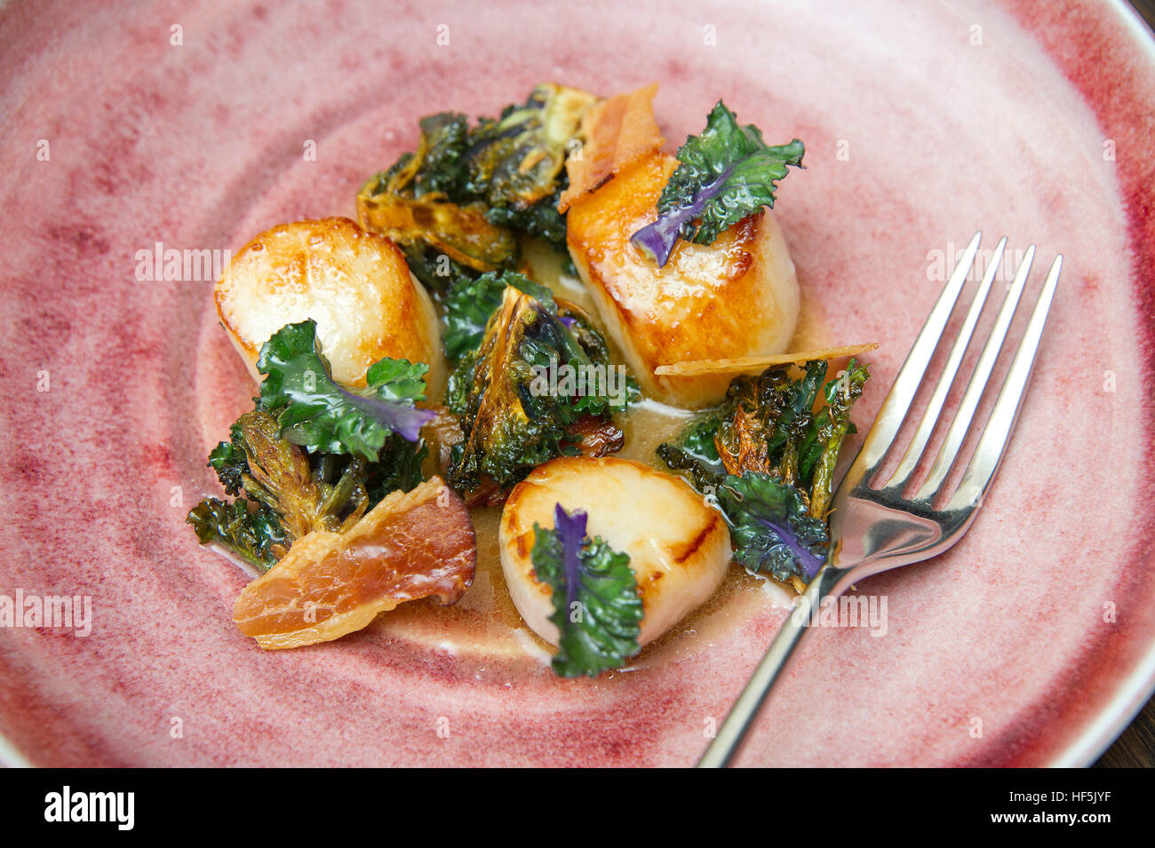 Kalettes being prepared, cooked and served in a scallop dish Stock Photo