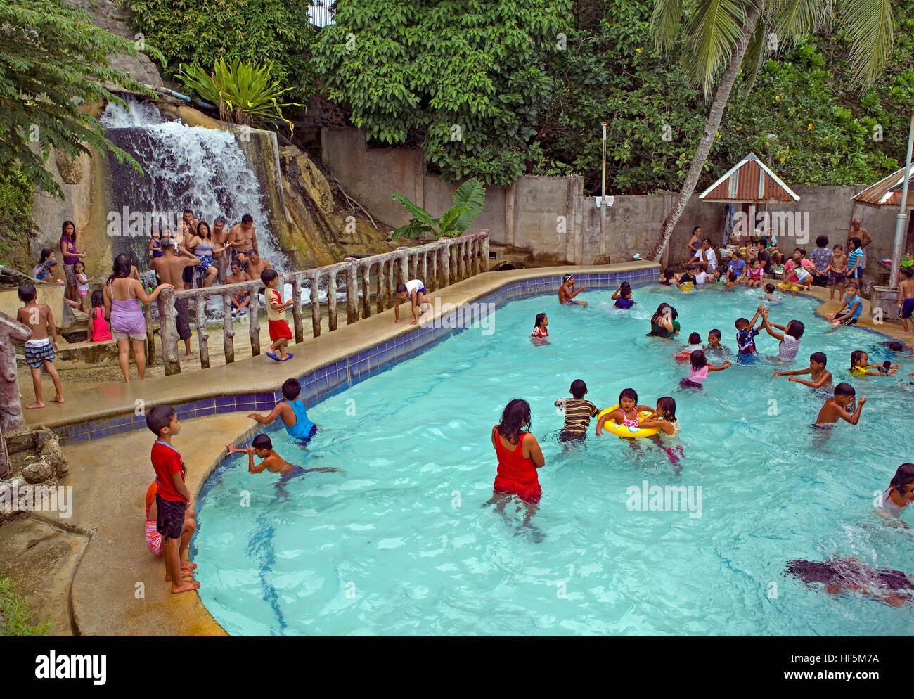 Filipino families and tourists enjoy the fresh water swimming pool at