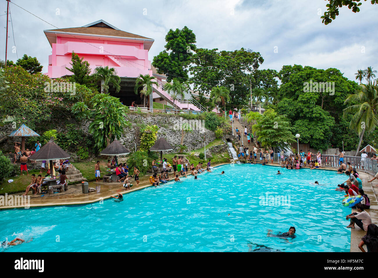 Filipino families and tourists enjoy the fresh water swimming pool at