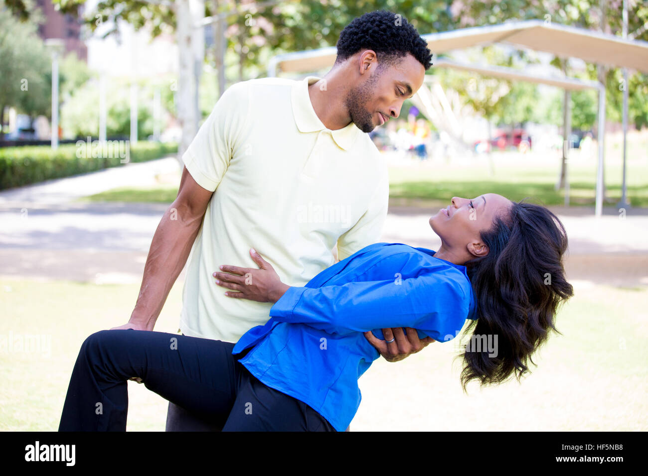 Closeup portrait of a young couple, guy holding woman in arms in dip