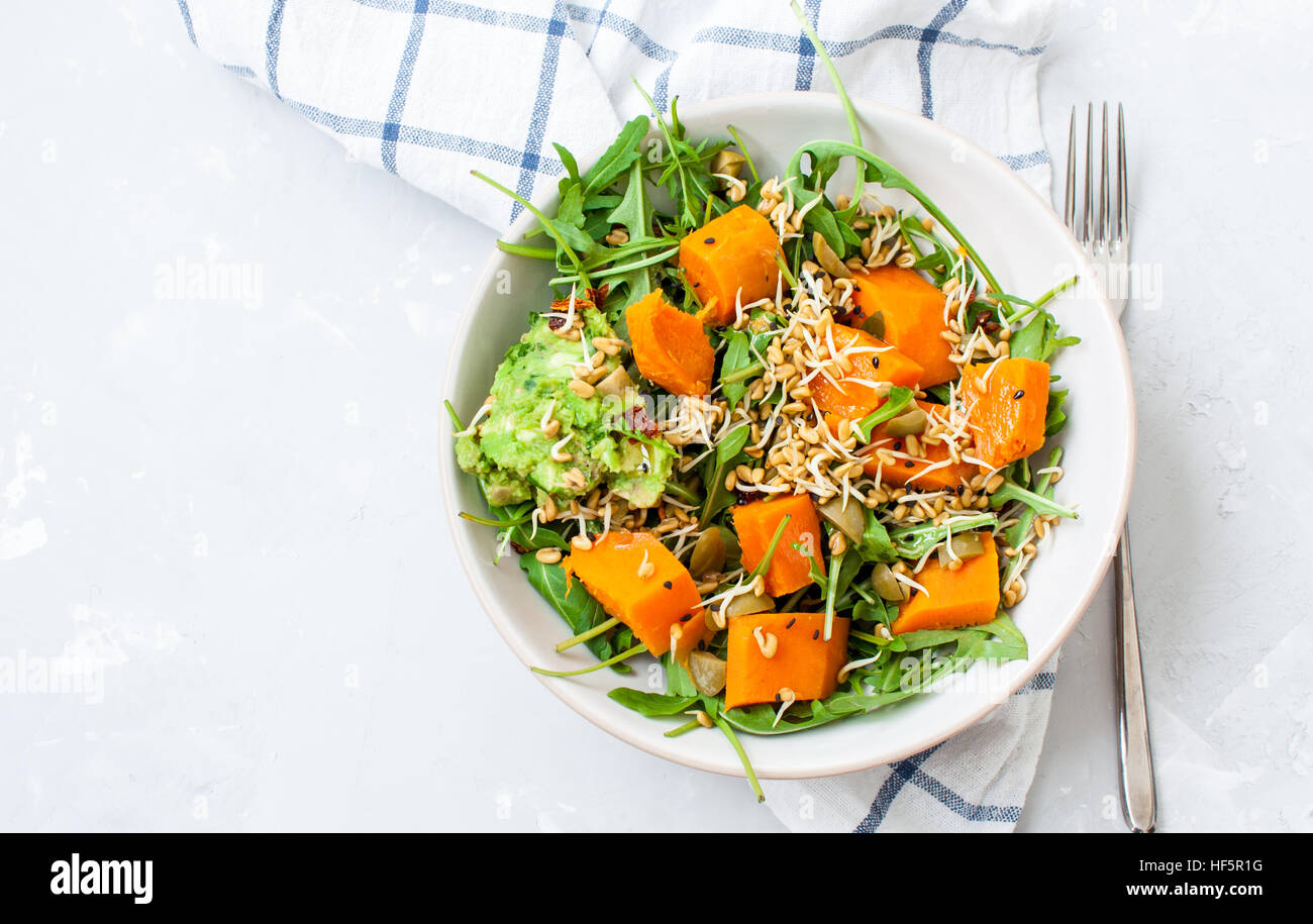 Green salad with sweet potatoes, guacamole and olives. Vegan healthy lunch or dinner. Love for a healthy raw food concept. Stock Photo