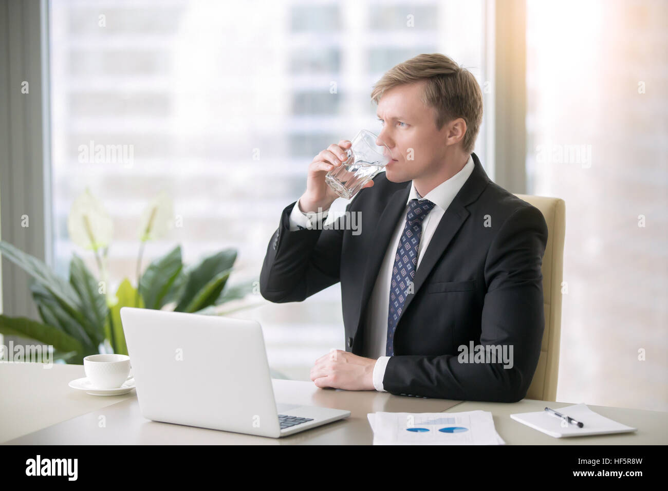 Businessman drinking water Stock Photo
