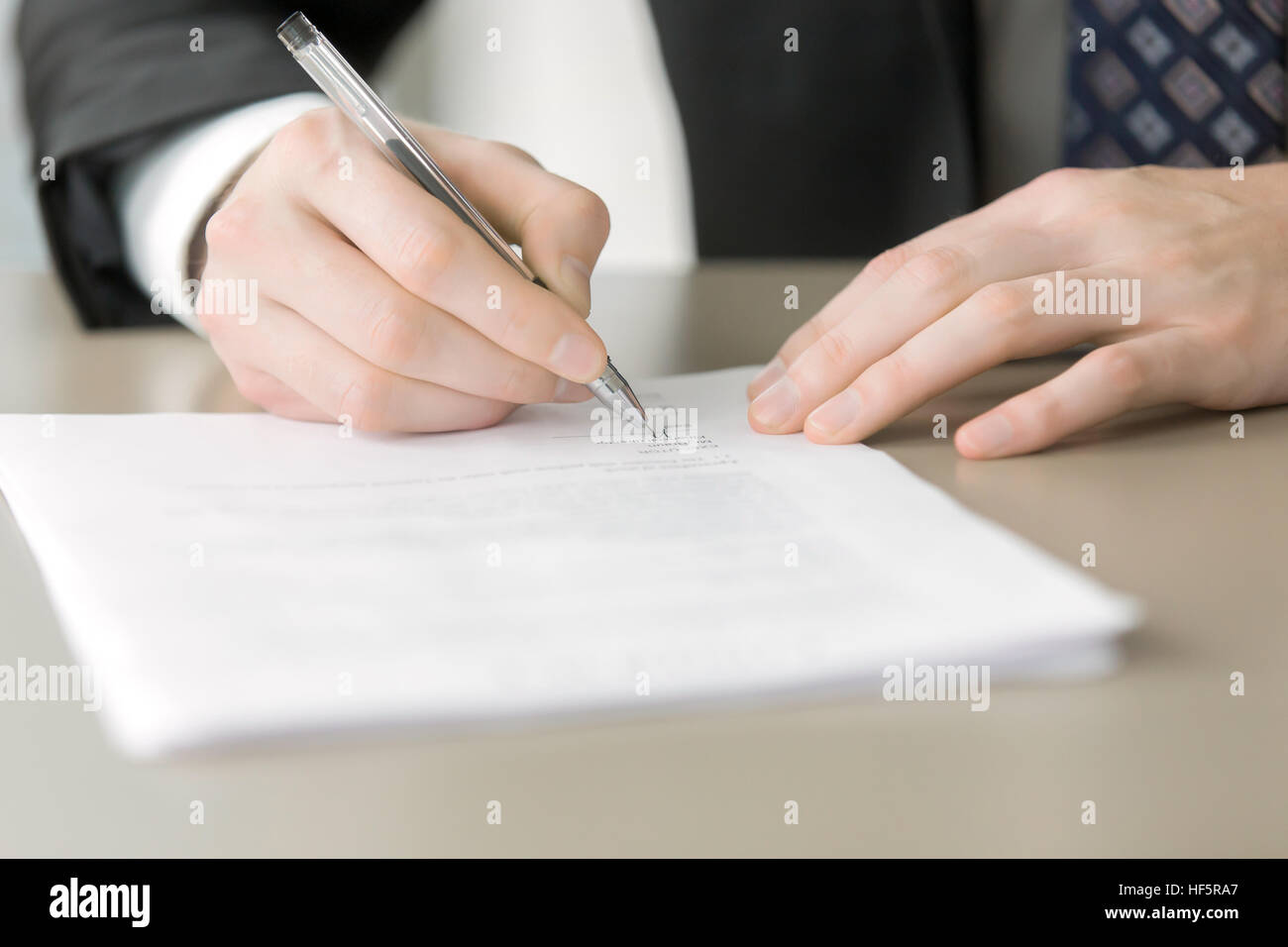 Close up of male hand putting signature Stock Photo
