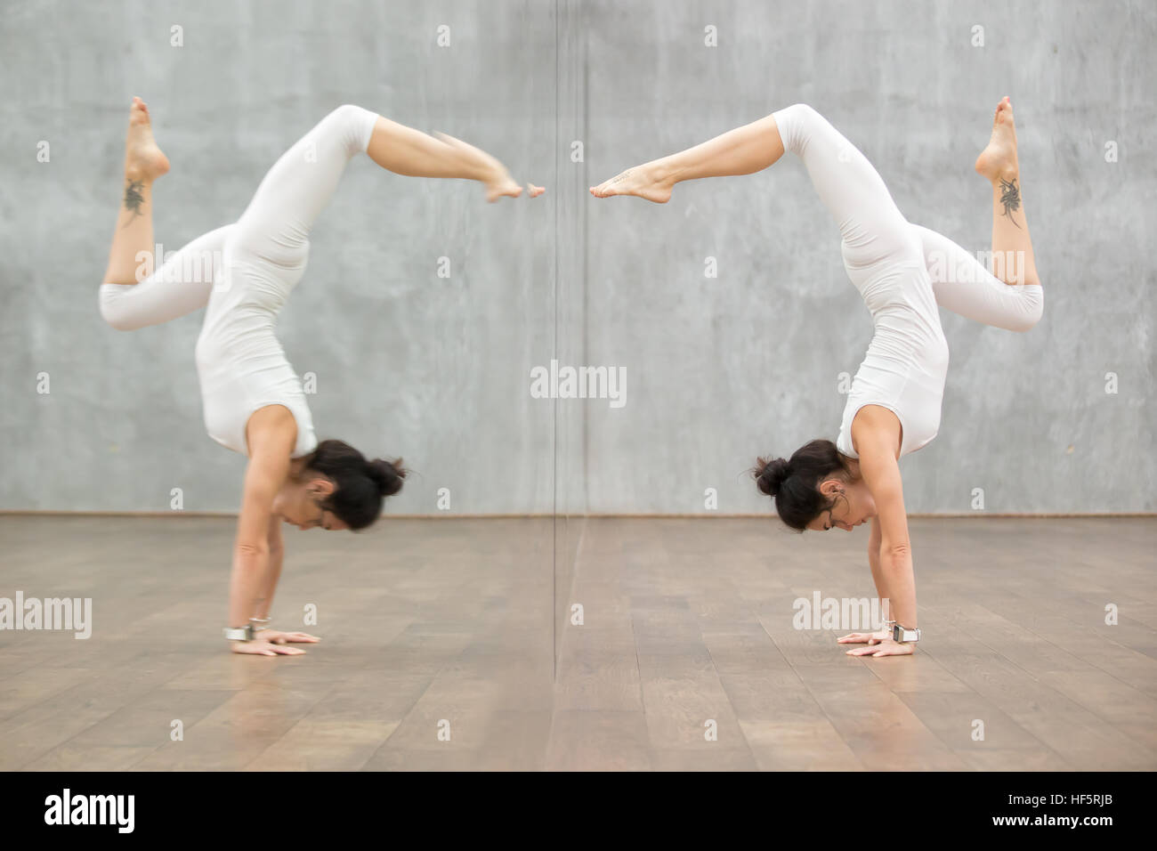 Beautiful Yoga: woman in handstand pose Stock Photo
