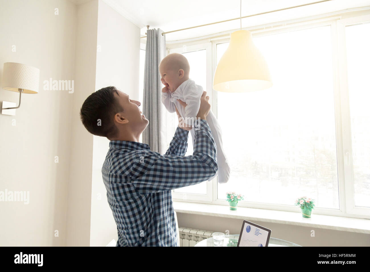 Young man throwing a baby Stock Photo Alamy