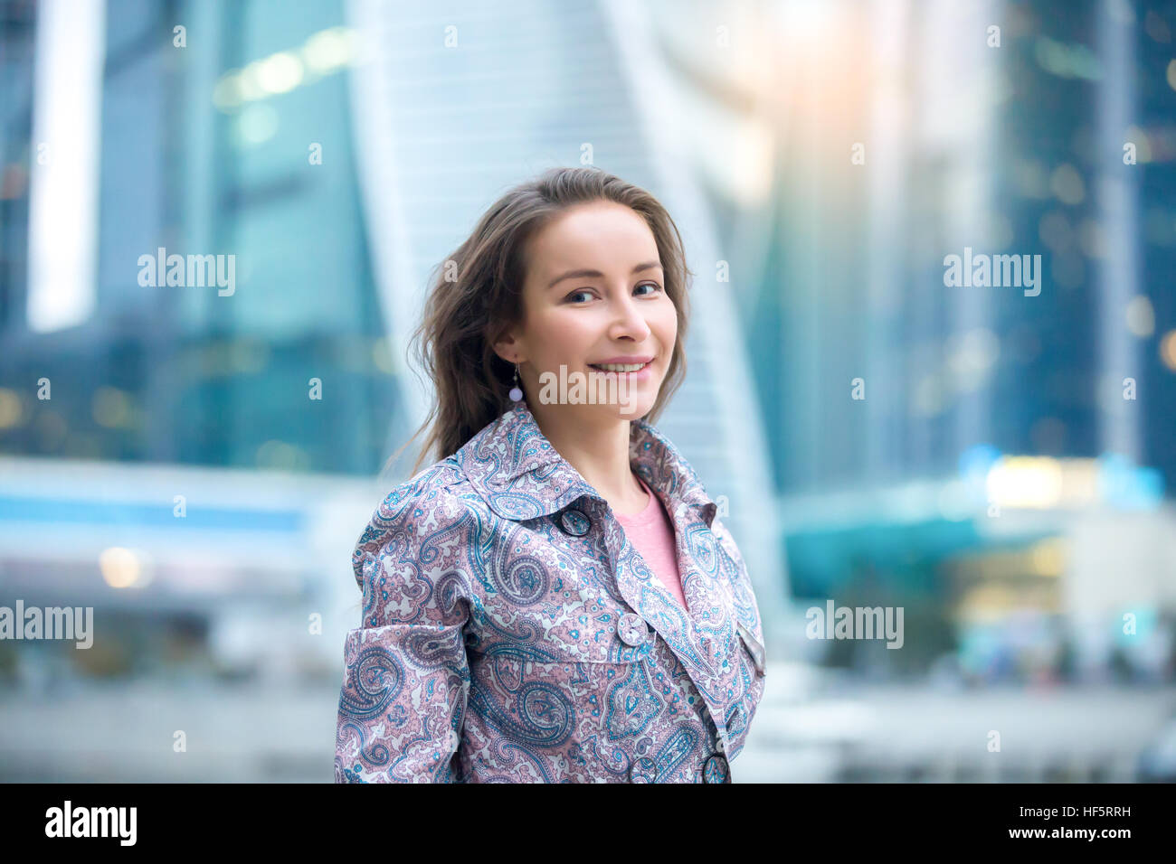 Portrait of a young smiling woman at the city street Stock Photo - Alamy
