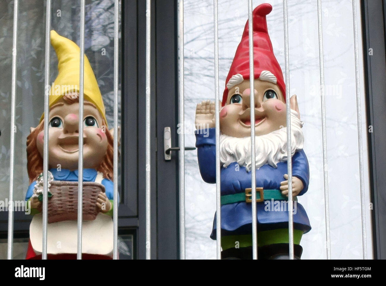 Gnomes on flat balcony appear to be in prison, Bermondsey, London Stock Photo