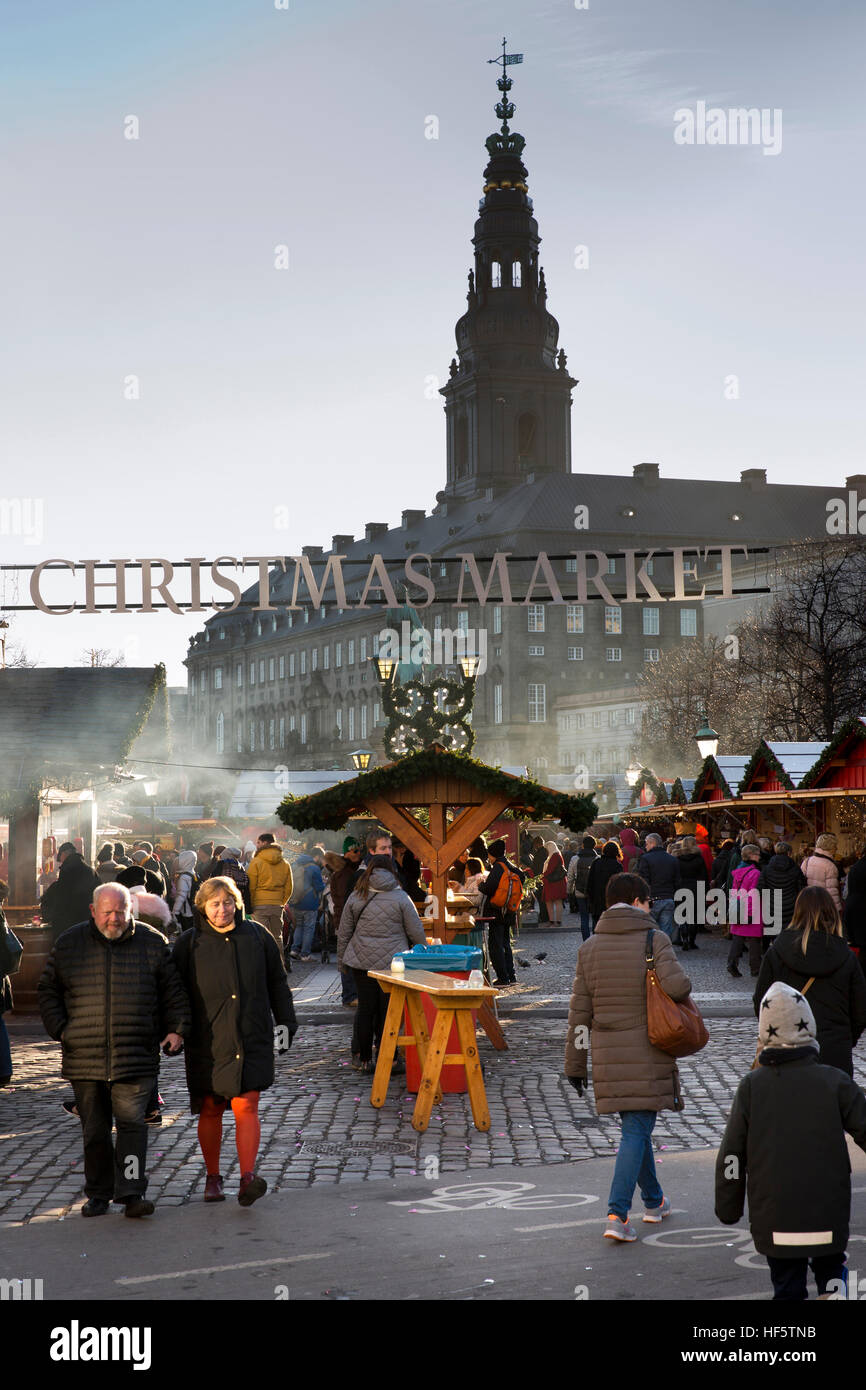 Denmark, Copenhagen, Højbro Plads, visitors in Christmas Market, with Christianborg Palace tower behind Stock Photo