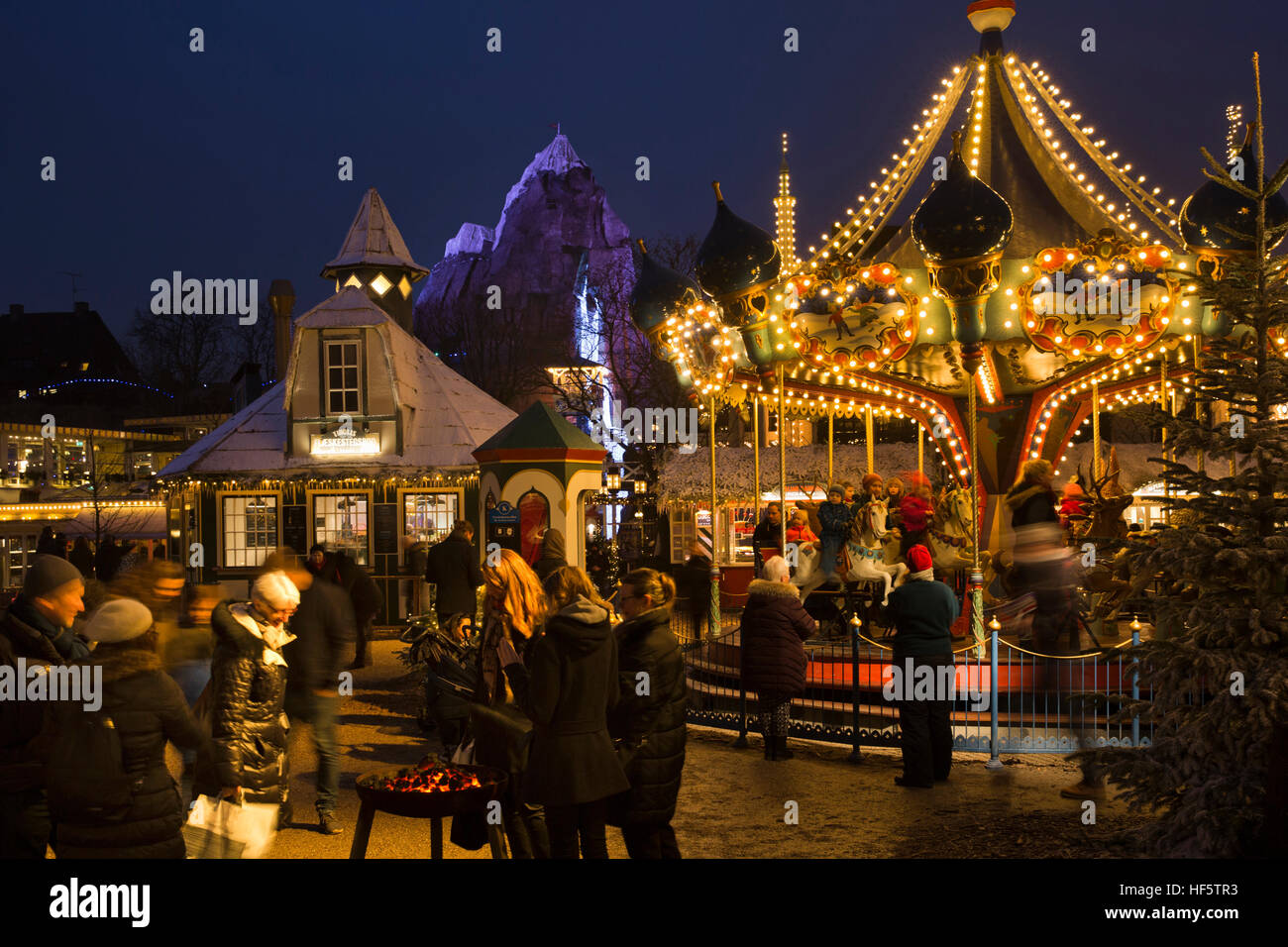 Denmark, Copenhagen, Tivoli Gardens, Christmas Market, illuminated merry go round at night Stock Photo