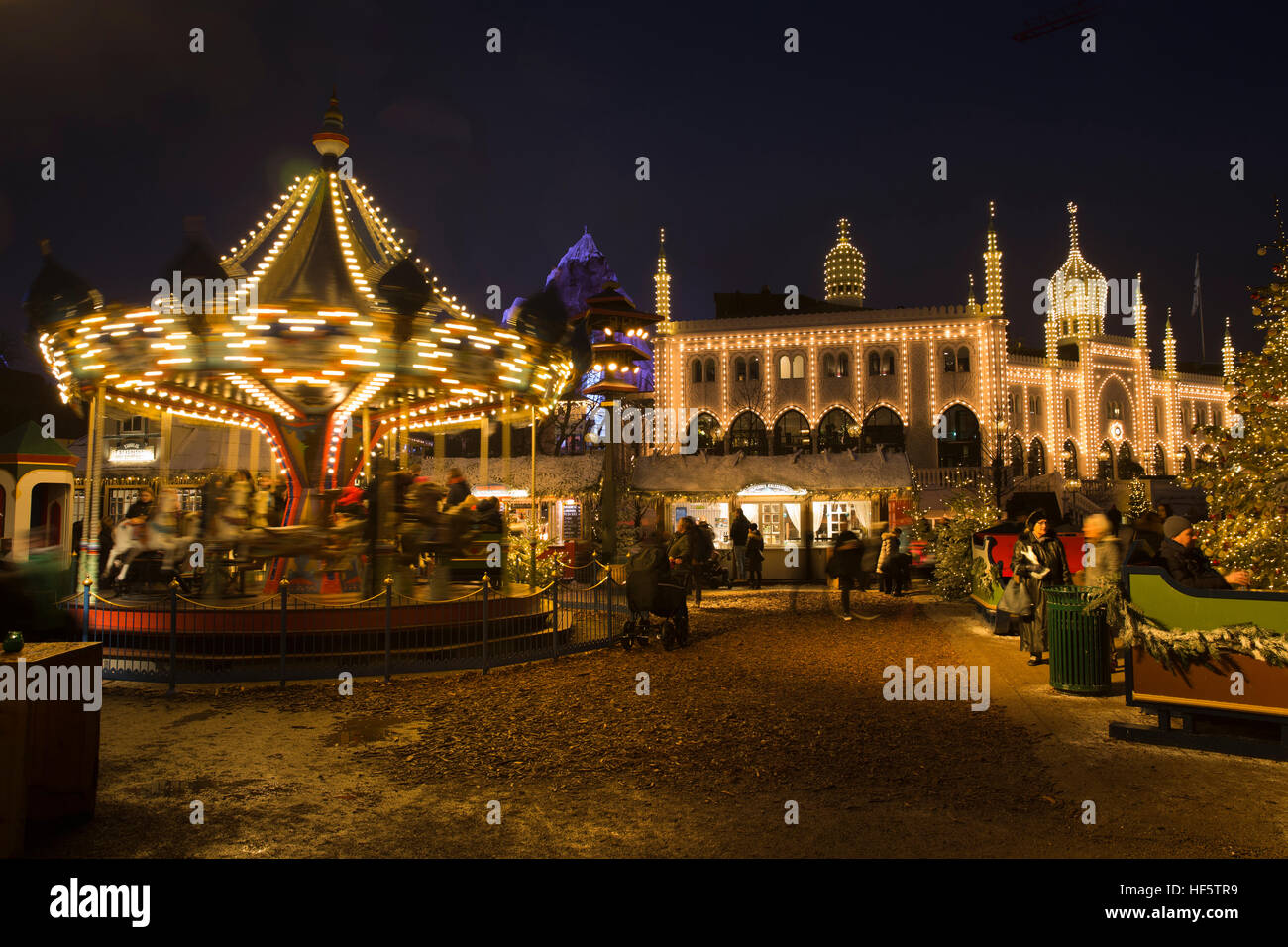 Denmark, Copenhagen, Tivoli Gardens, Christmas Market, illuminated merry go round and Oriental Palace at night Stock Photo