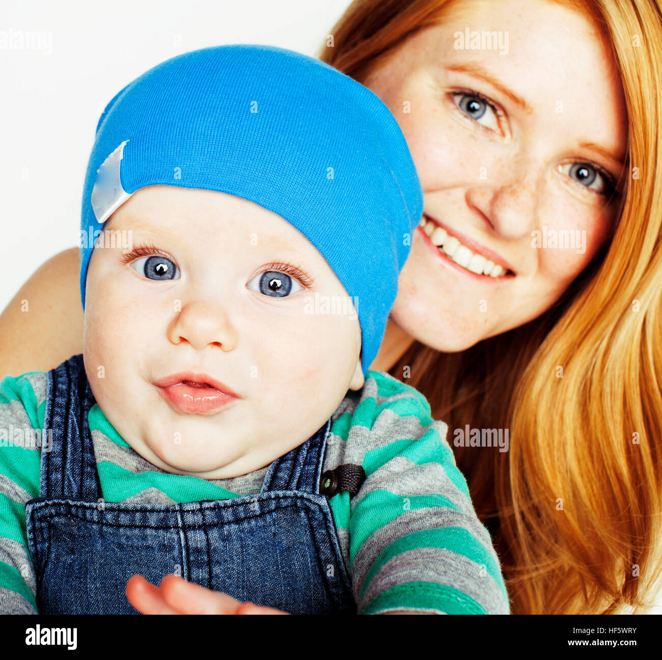 young beauty mother with cute baby, red head happy modern family Stock