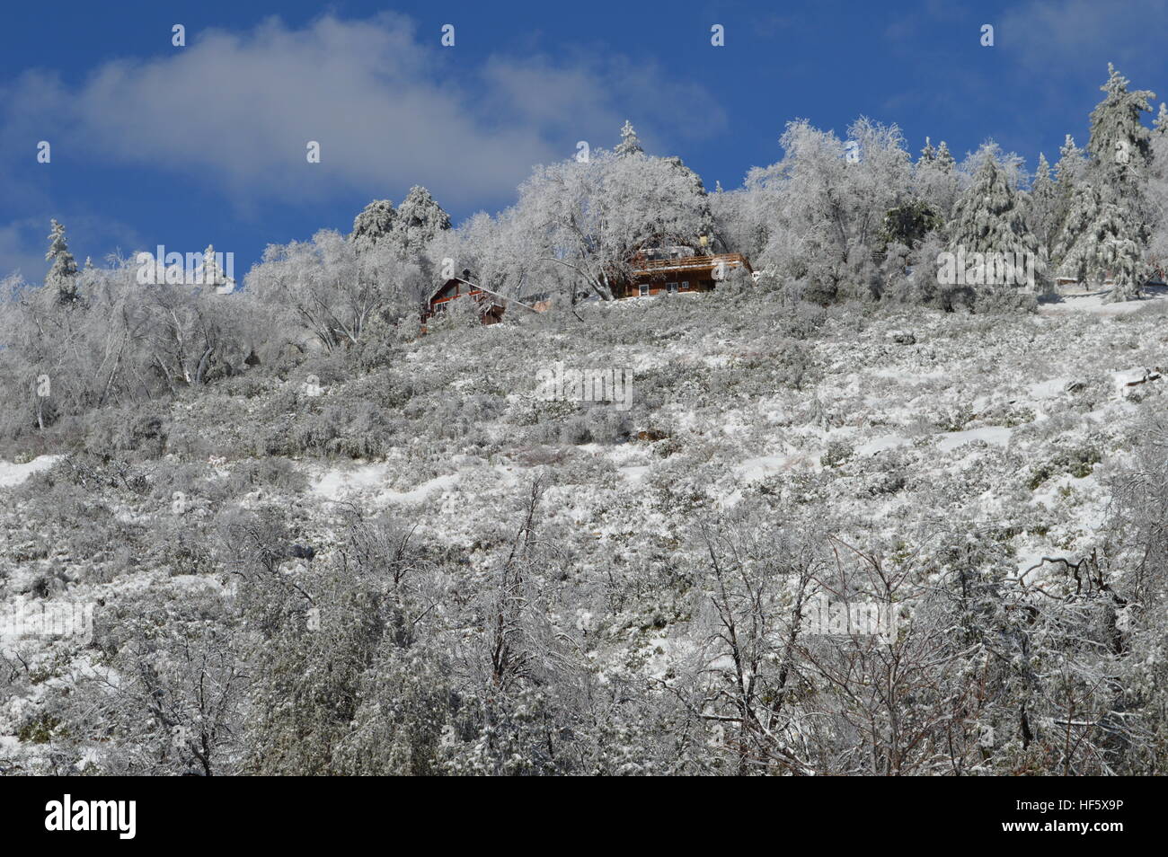 House on mountain top in snow Stock Photo