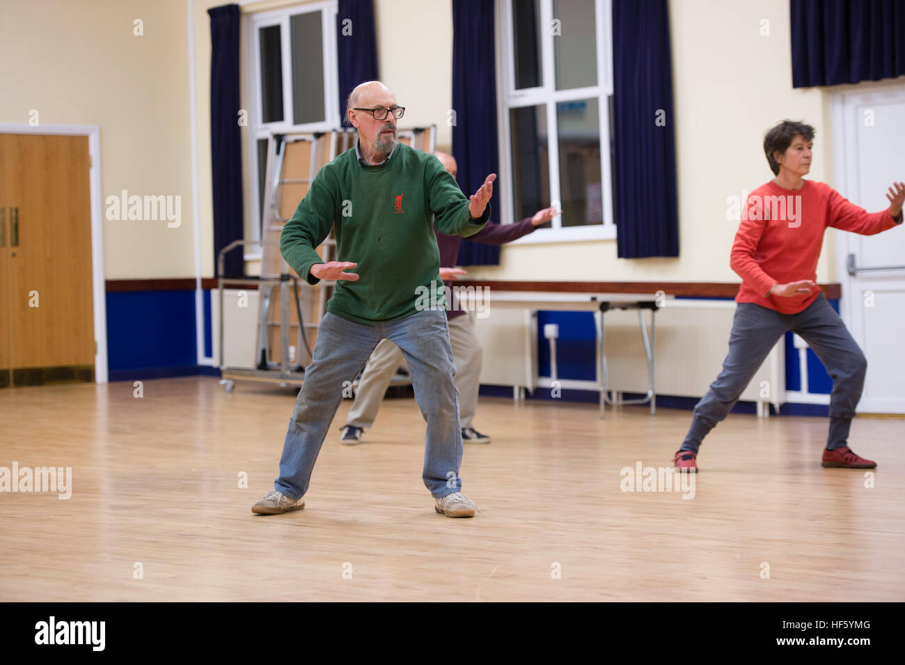 A group of middle aged people taking part in a Tai Chi class at Tregaron Memorial Hall, a small village hall modernised with updated facilities with financial support from the Lottery Heritage Fund.  Ceredigion, Wales UK Stock Photo
