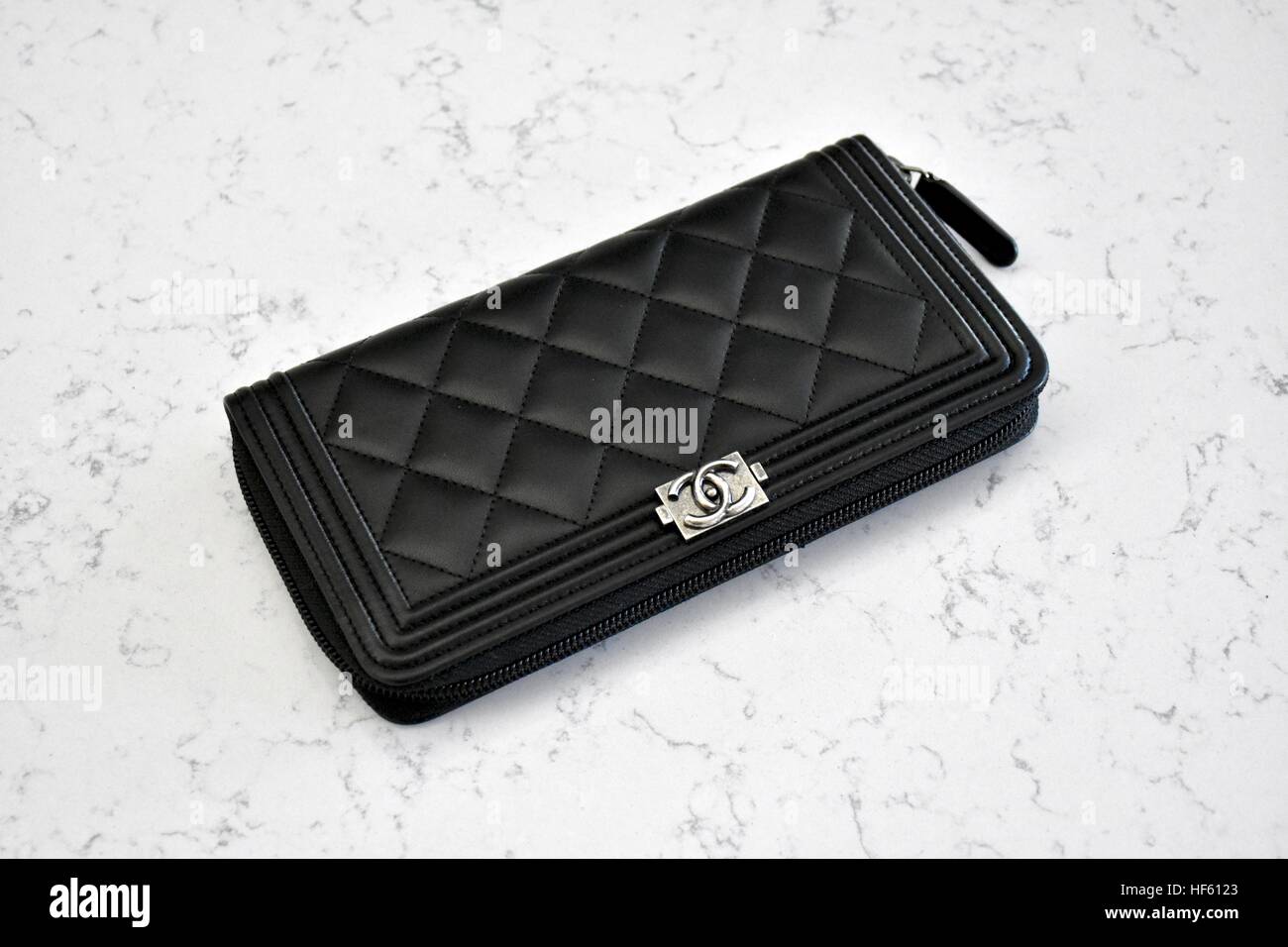 A Chanel boyfriend wallet displayed on a white carrera marble background  Stock Photo - Alamy
