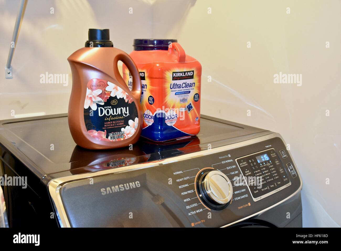 Washing machine pods and fabric softener sitting on top of the washer