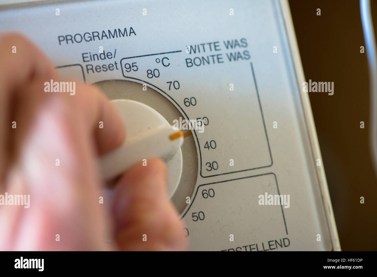 hand and switch at washing machine Stock Photo Alamy