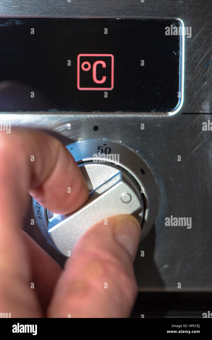 hand and switch at oven Stock Photo Alamy