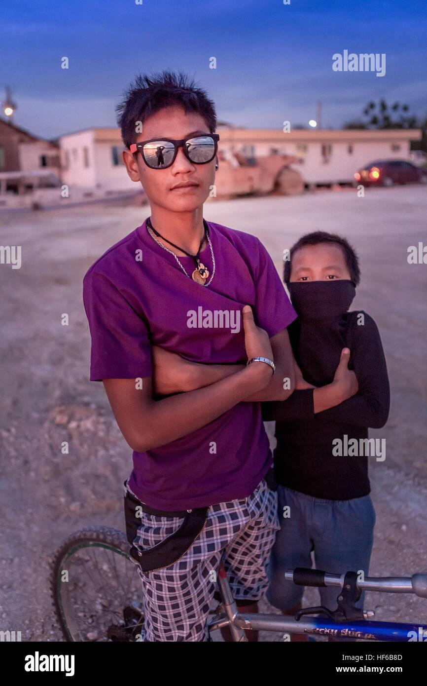 A young boy emulates his older brother by playing the tough guy at Bogo City, Cebu Island, Philippines. Stock Photo