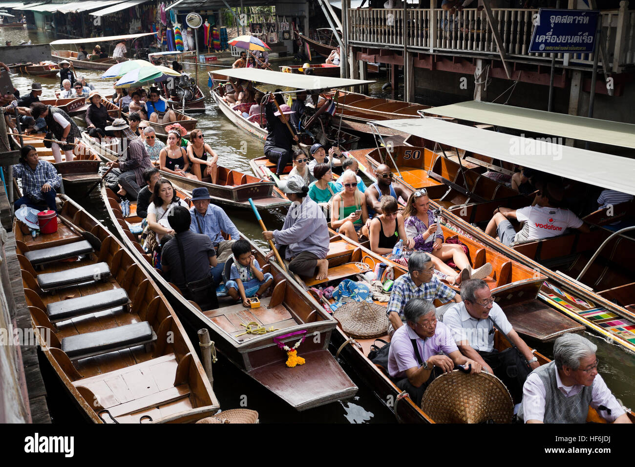 Intense boat traffic in the canals of the floating markets in Bangkok, Thailand Stock Photo