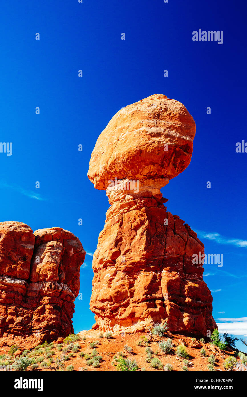 Balanced Rock - a boulder estimated at 3500 tons weight - sits perched on a precarious pedestal - Arches National Park, Utah, USA Stock Photo