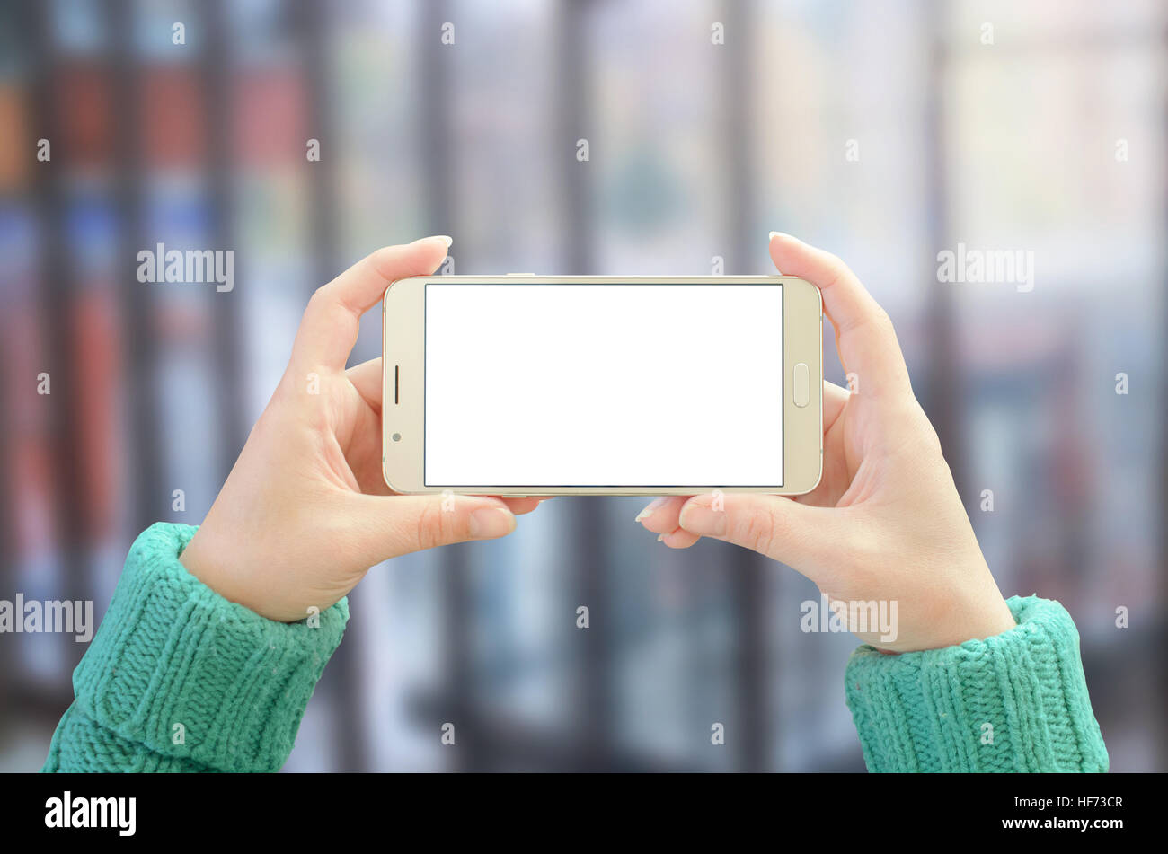 Smart phone horizontal position in woman hand. Isolated, white screen for mockup. App or web site promotion. Stock Photo