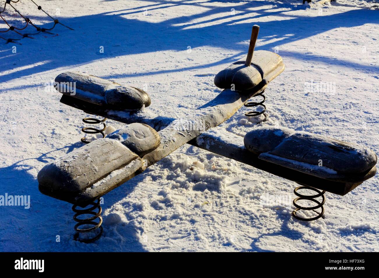 Children's swings and slides in the snow in the winter Stock Photo