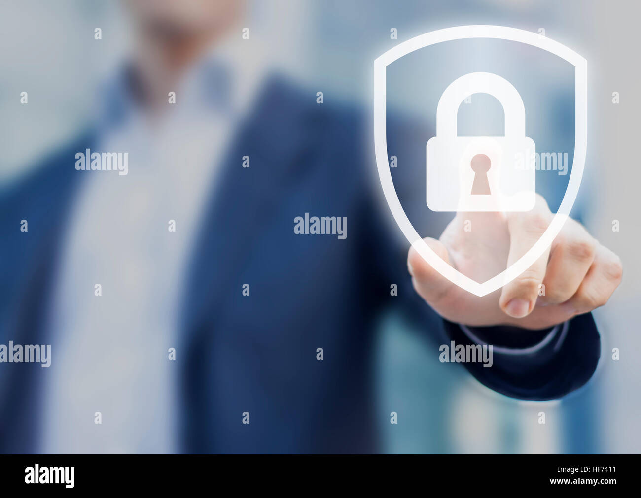 Person touching a shield with a lock symbol, concept about security, cybersecurity and protection against dangers Stock Photo