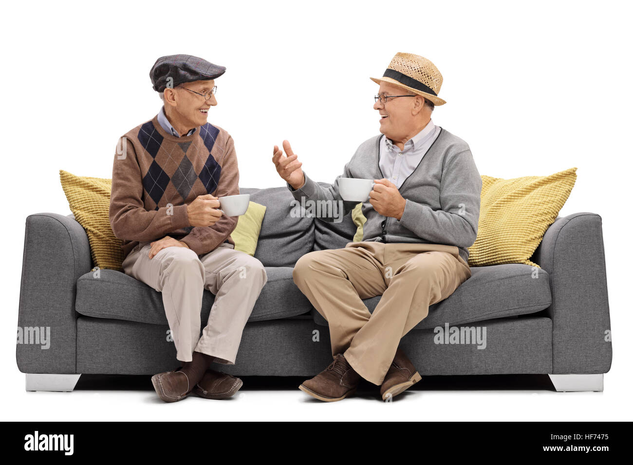 Seniors sitting on a sofa and talking isolated on white background Stock  Photo - Alamy