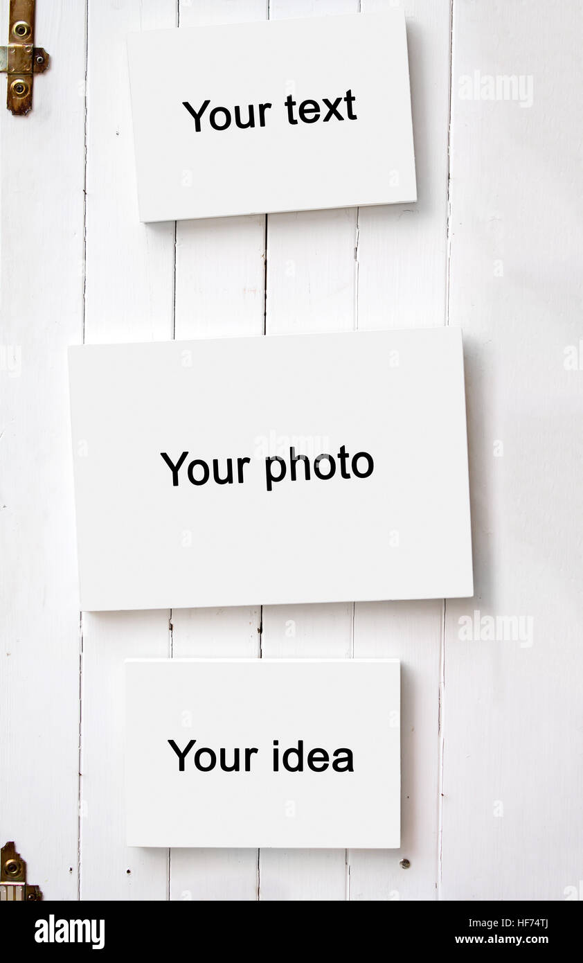 Three blank frame on white wooden wall Stock Photo