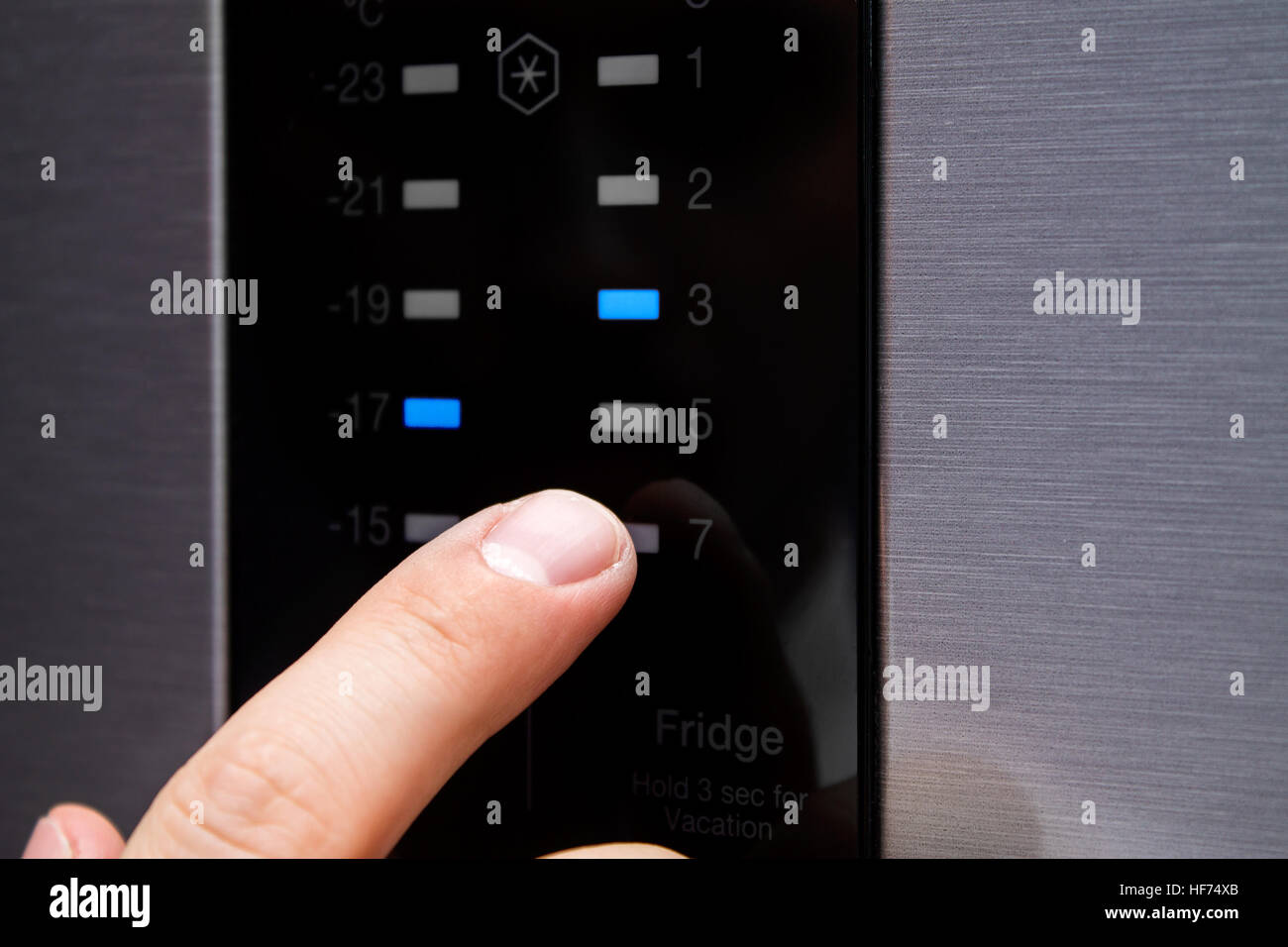 https://c8.alamy.com/comp/HF74XB/man-sets-the-temperature-in-the-modern-refrigerator-on-touch-panel-HF74XB.jpg