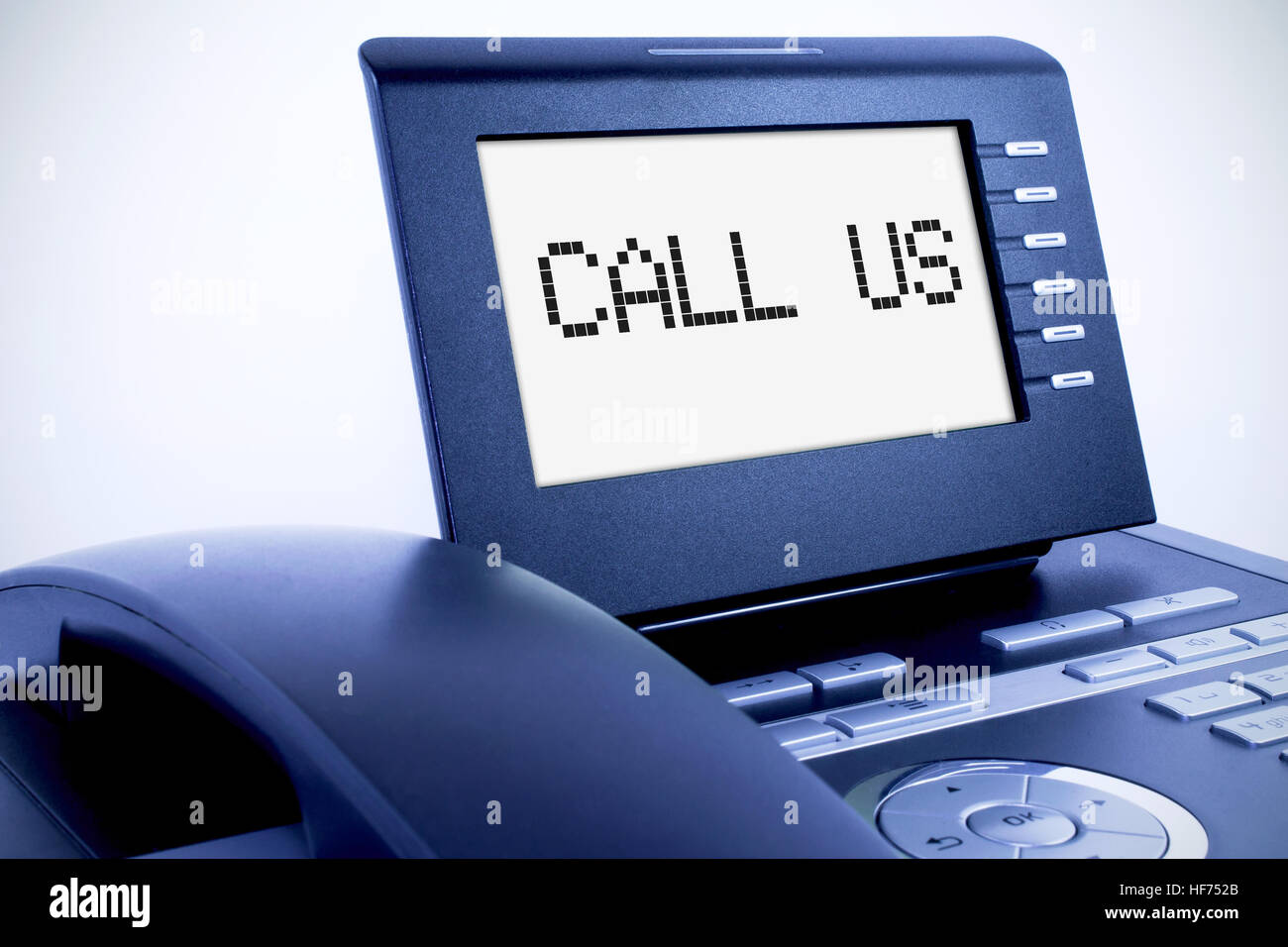 Modern phone with a display sign 'Call Us' Stock Photo