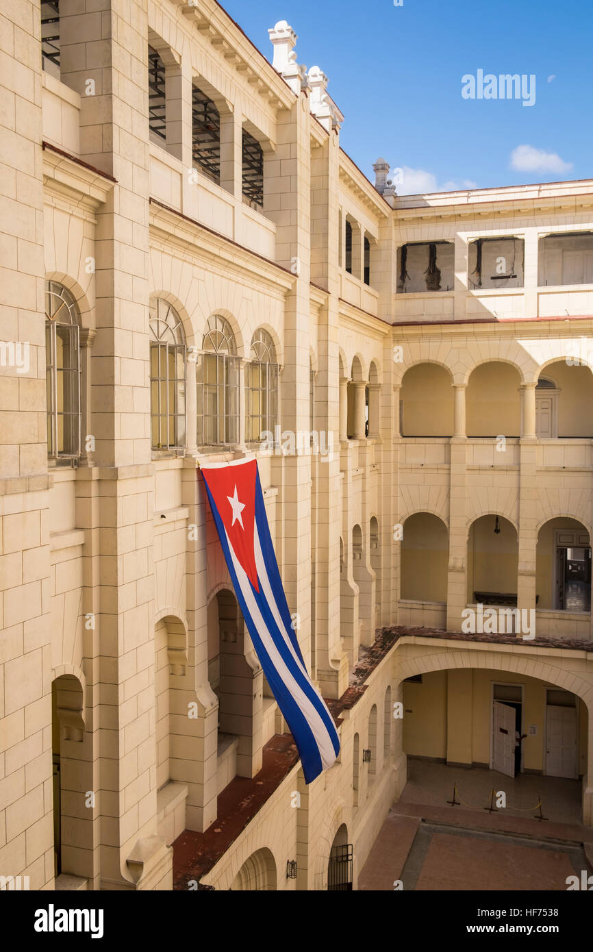 Large Cuban flag hangs in the courtyard of the Museo de la Revolucion, La Havana, Cuba. Stock Photo