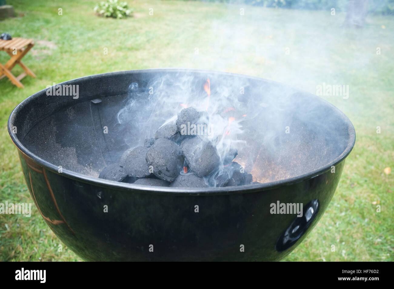 Smoke coming out of grill in backyard Stock Photo - Alamy