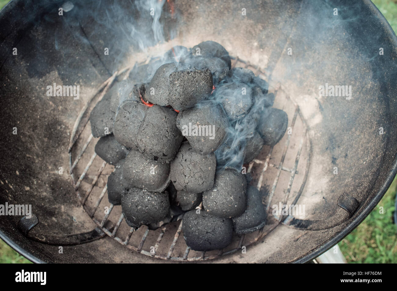 Smoke coming out of grill with briquette, closeup Stock Photo - Alamy