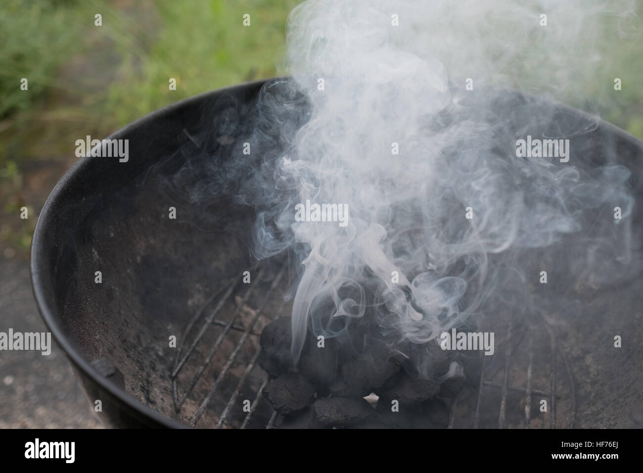 Smoke coming out of grill with briquette, closeup Stock Photo - Alamy