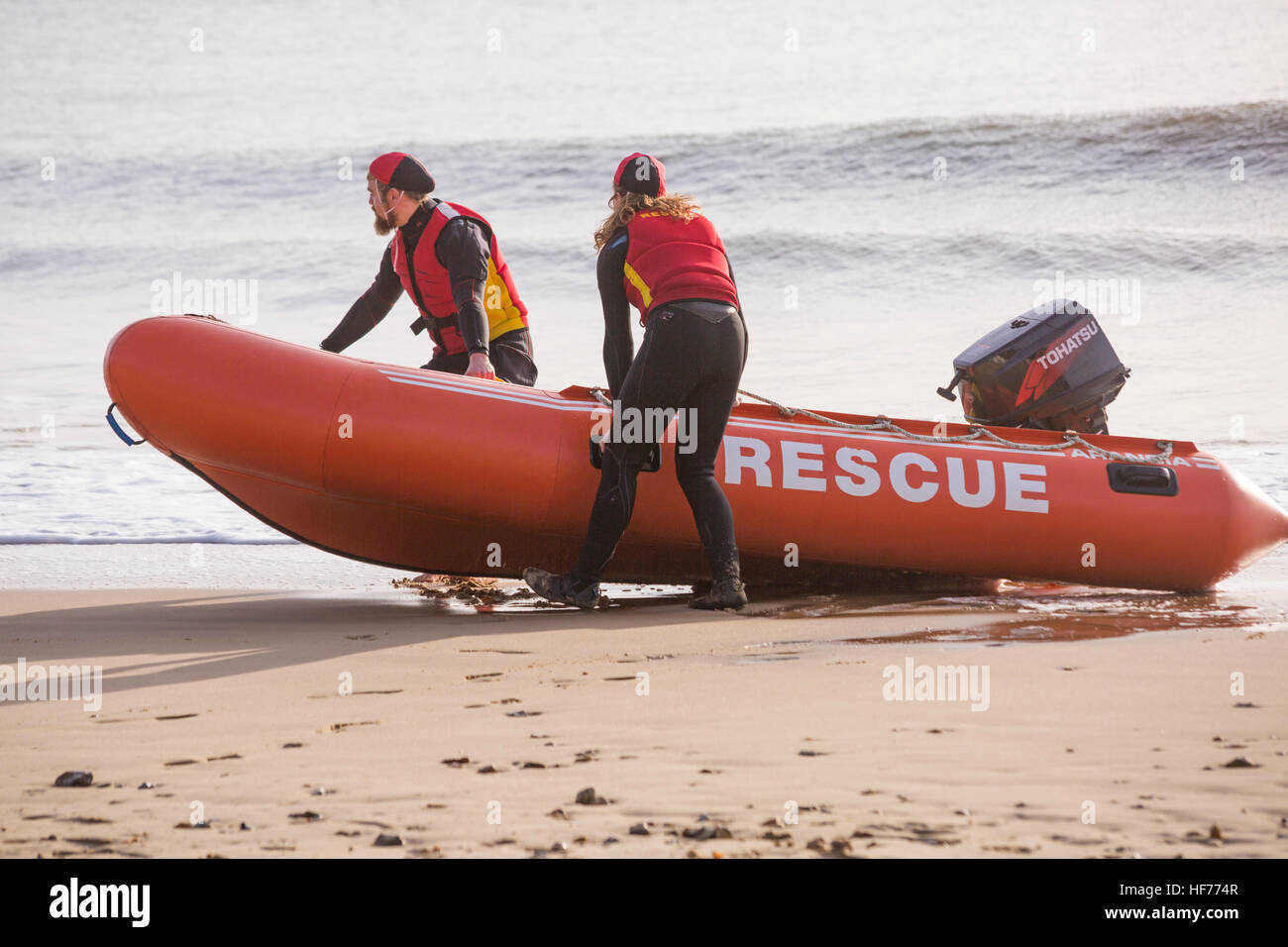 Bournemouth Lifeguard Corps give a demonstration of their lifesaving skills in the sea at Durley Chine beach, Bournemouth, UK on Boxing Day Stock Photo